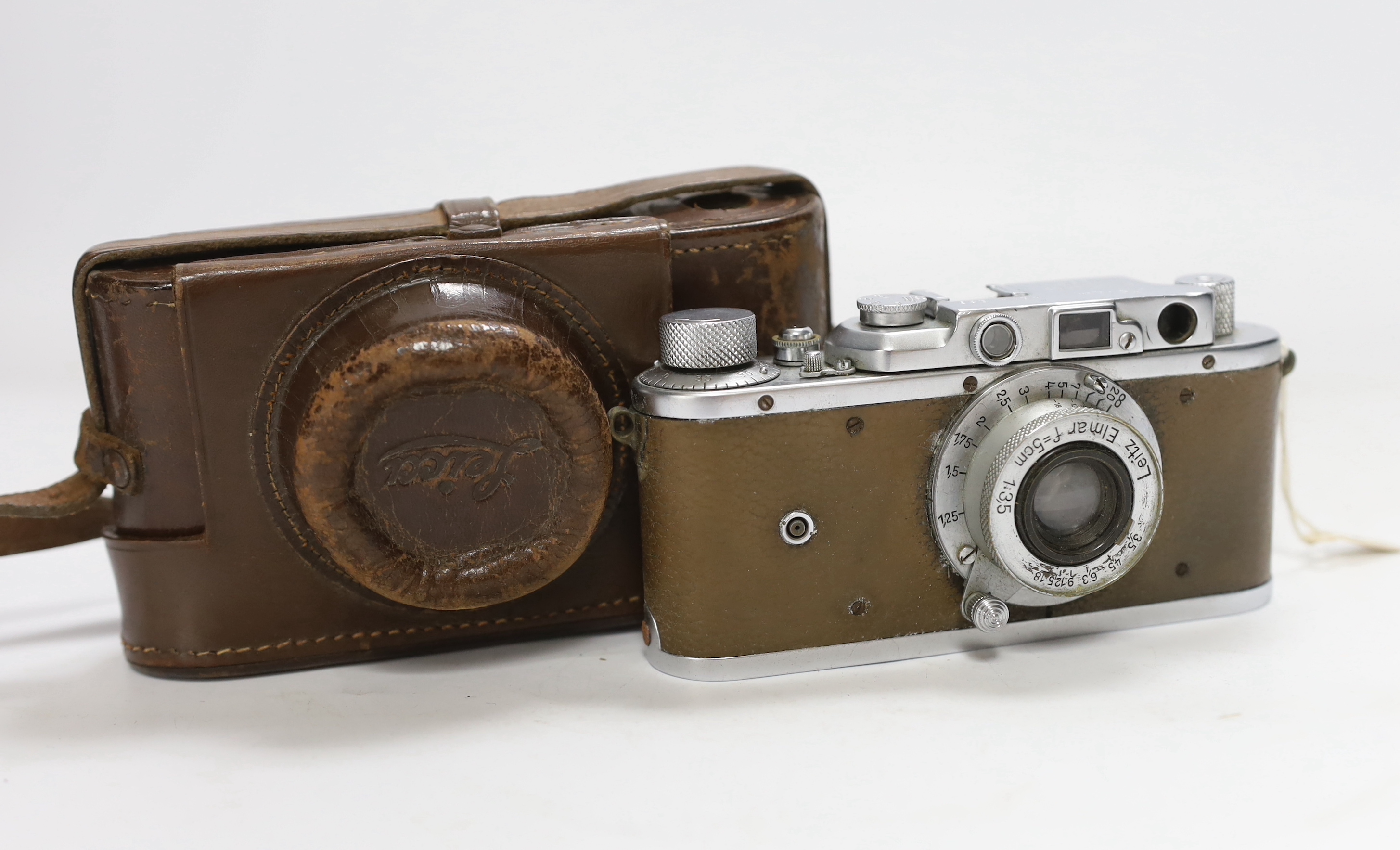 A Leica III camera, No.144286, with an Elmar f=5cm 1:3,5 lens, with leather case and strap